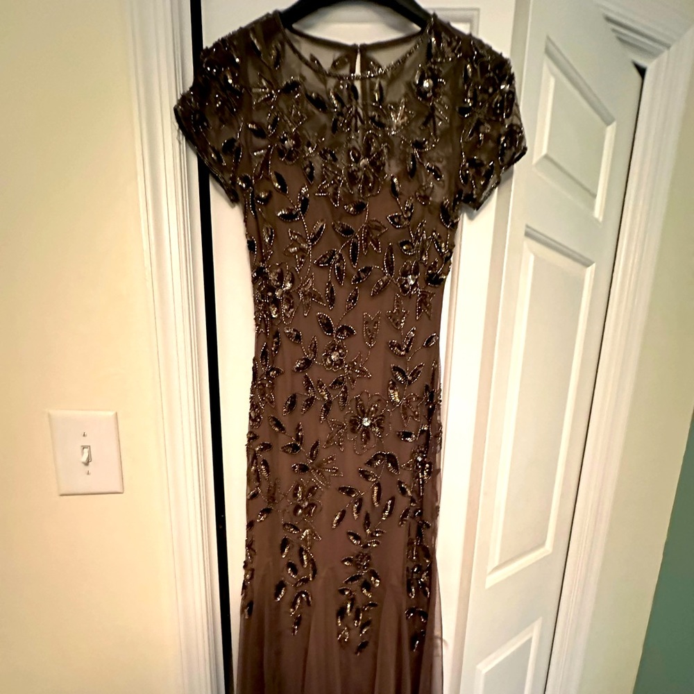 Worn once. Detailed in sequins (all intact) bodice is tulle. I am 65” tall.